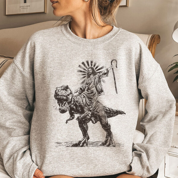 jesus riding a dinosaur sweater
